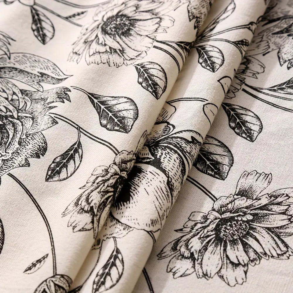 Black floral tasseled farmhouse tablecloth with a classic design and a mix of lace and tassels, perfect for farmhouse decor.