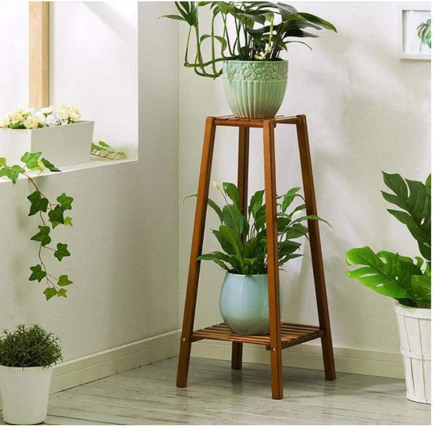 Tiered bamboo plant stand for displaying plants indoors and outdoors.