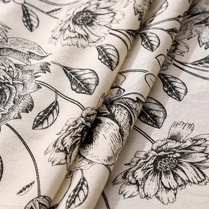 Black floral tasseled farmhouse tablecloth with a classic design and a mix of lace and tassels, perfect for farmhouse decor.