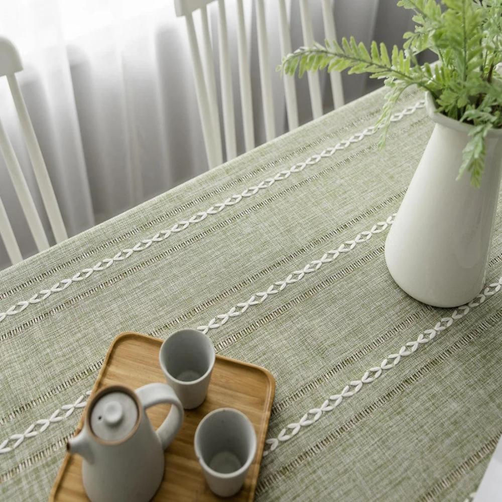 Close-up of architectural sage linen tablecloth with Kintsugi pattern and linen texture