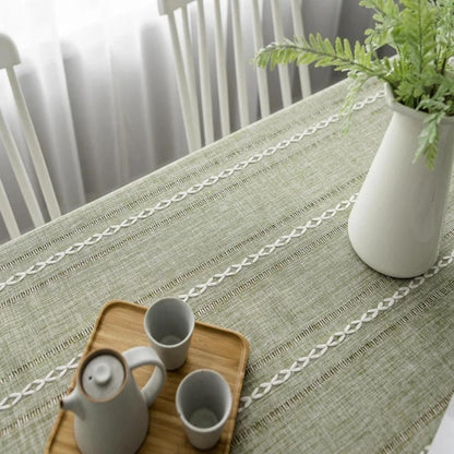 Close-up of architectural sage linen tablecloth with Kintsugi pattern and linen texture