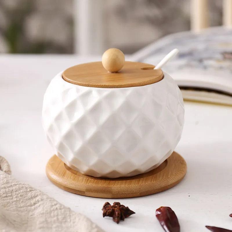 Side view of modern ceramic and wood sugar bowl with lid