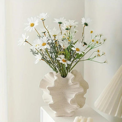 Close-up of a minimalist coral vase made from ceramic, featuring a cream matte finish.