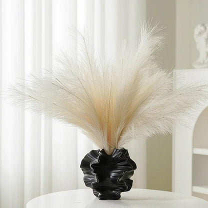 Side view of a minimalist coral vase made from ceramic, showcasing a cream matte finish.