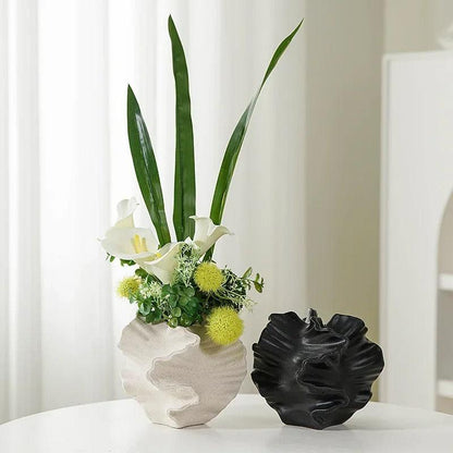 Front view of a minimalist coral vase made from ceramic, highlighting a cream matte finish.