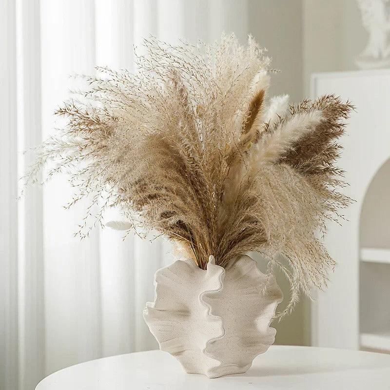 Back view of a minimalist coral vase made from ceramic, featuring a cream matte finish.