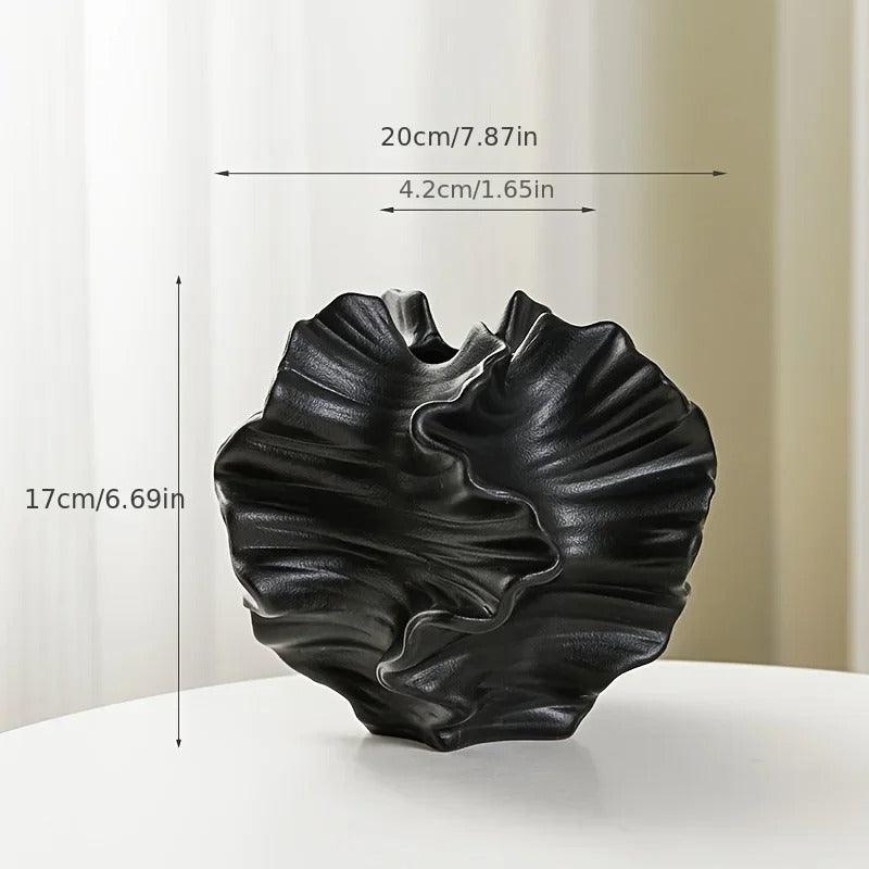 Detailed view of a minimalist coral vase made from ceramic, highlighting a cream matte finish.