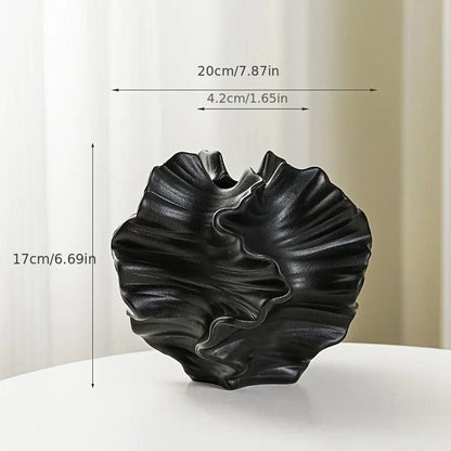 Detailed view of a minimalist coral vase made from ceramic, highlighting a cream matte finish.