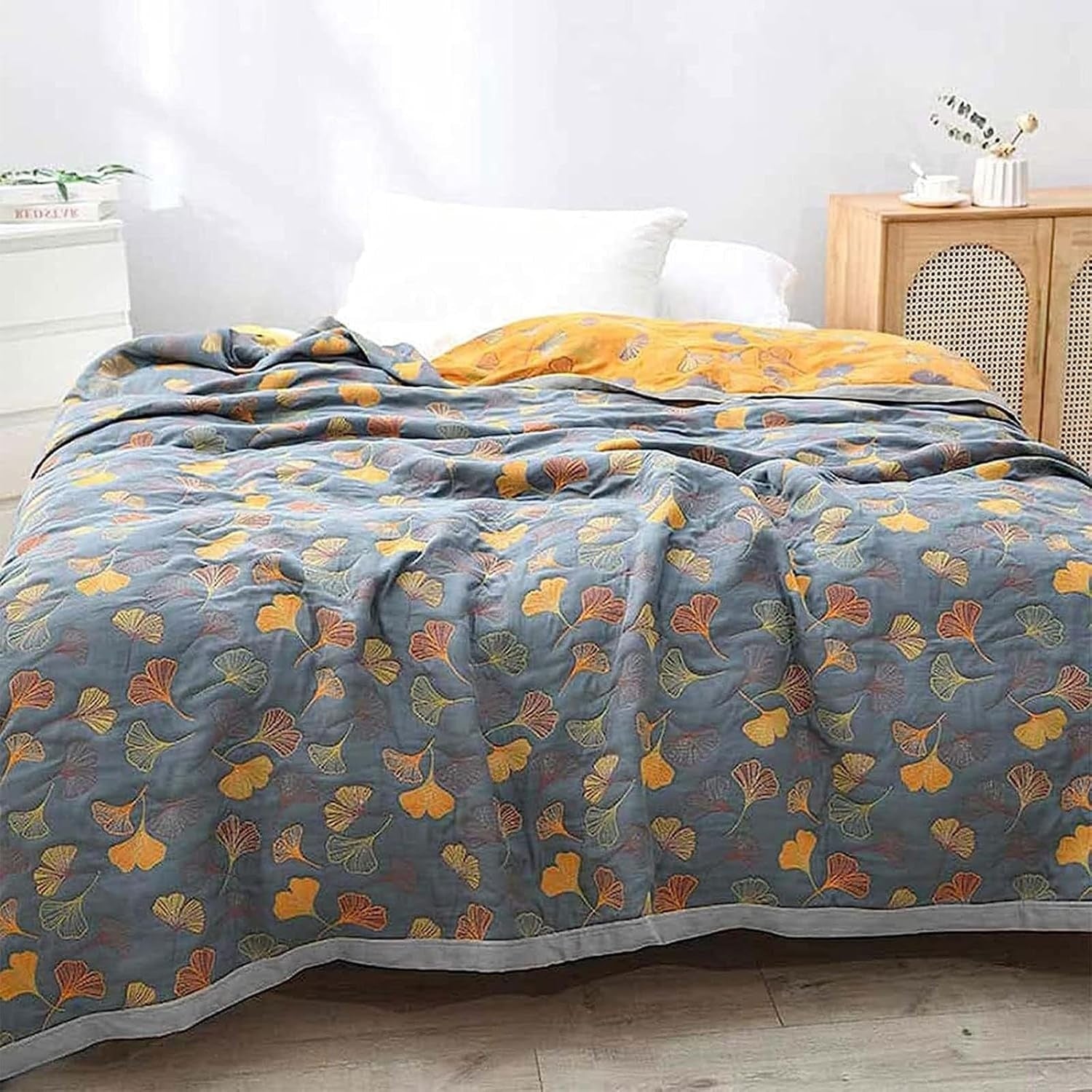 Beautifully woven Elara Haus reversible cotton throw showcasing ginkgo leaf patterns