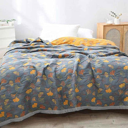 Beautifully woven Elara Haus reversible cotton throw showcasing ginkgo leaf patterns