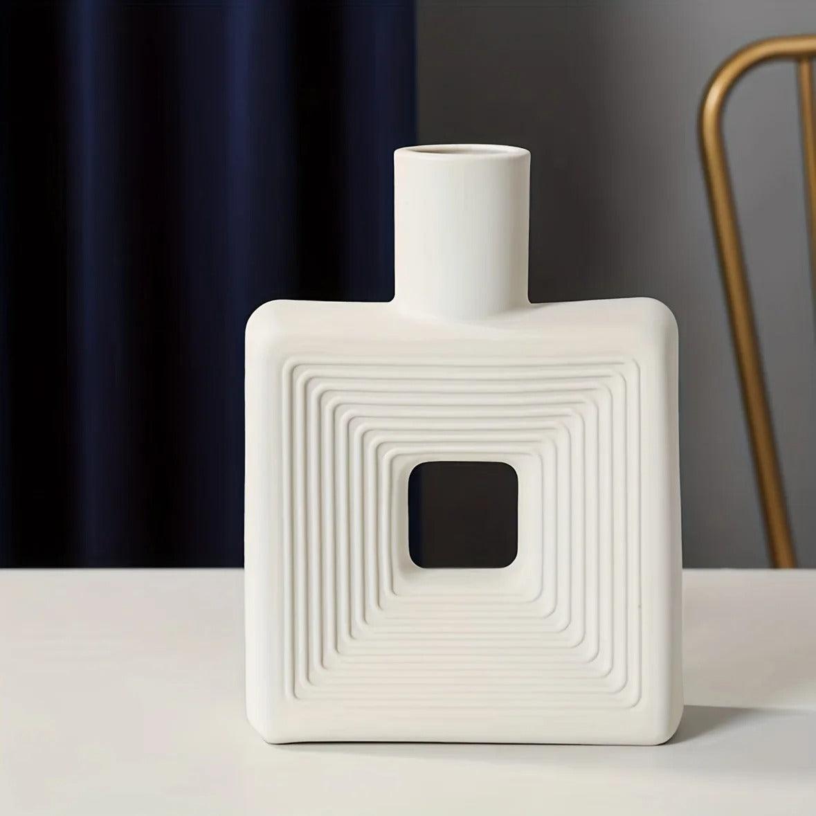 Stylized square vase made from ceramic material for minimalist decor.